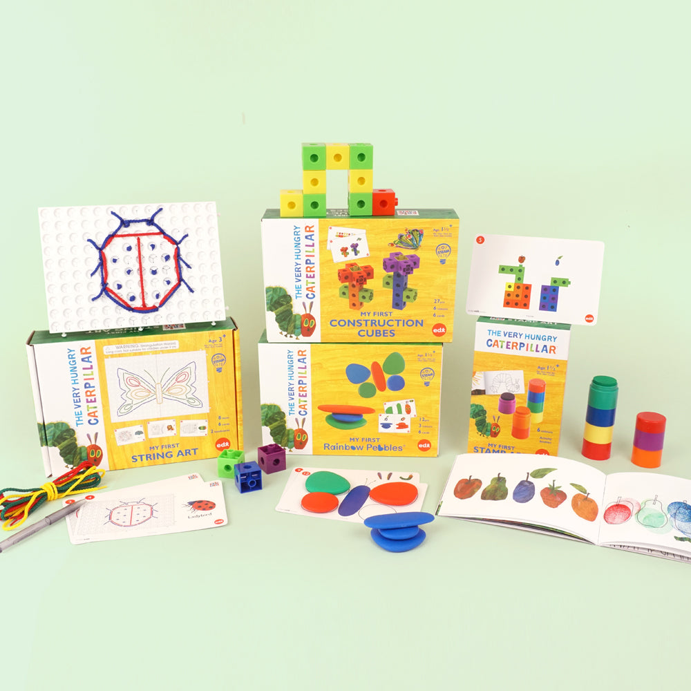 The Very Hungry Caterpillar™ early learning collection – shown with My First Construction Cubes, Rainbow Pebbles, String Art, Stacking Cups and activity cards for educational STEM development.