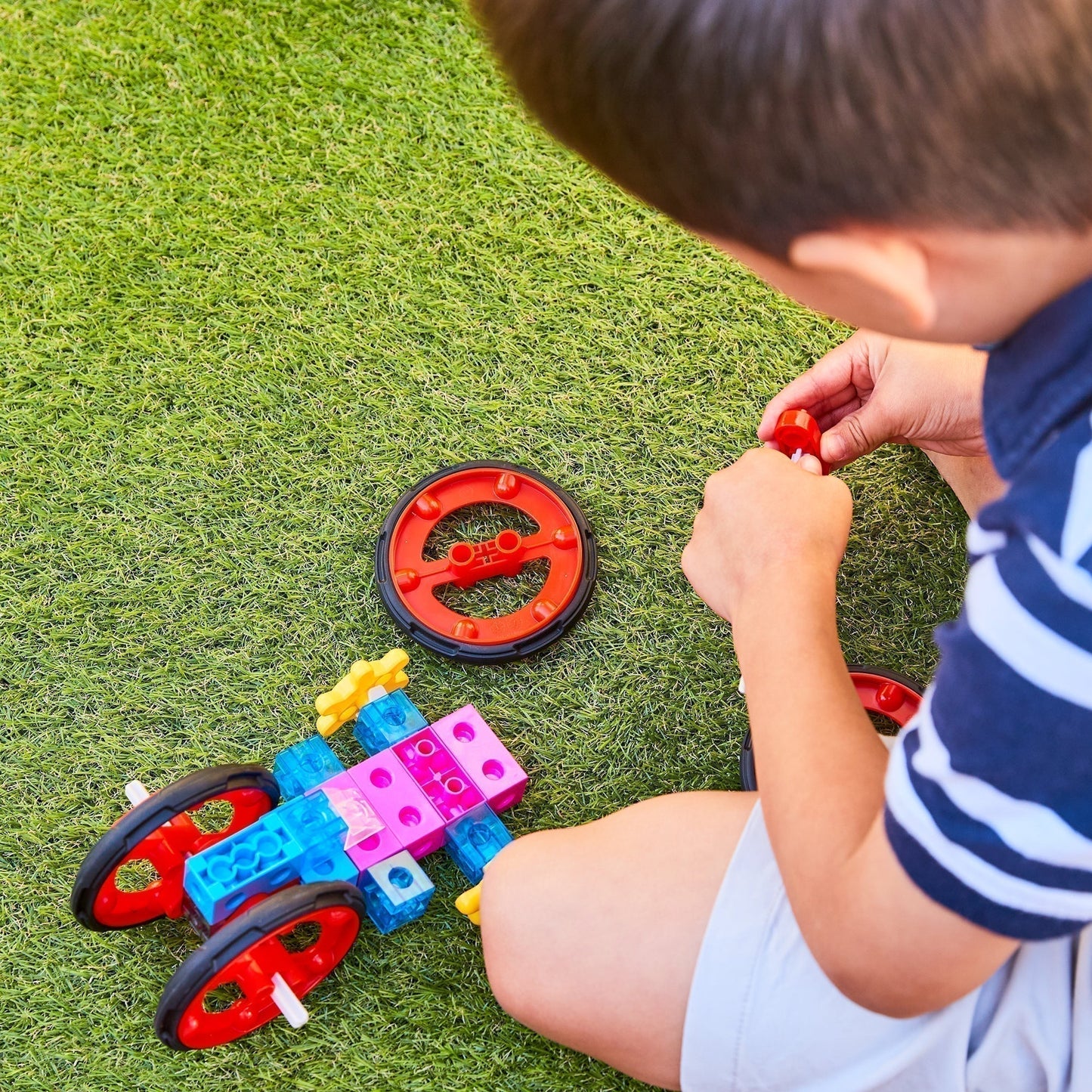 Children engaging in parallel play with open-ended toys in a calm shared play space