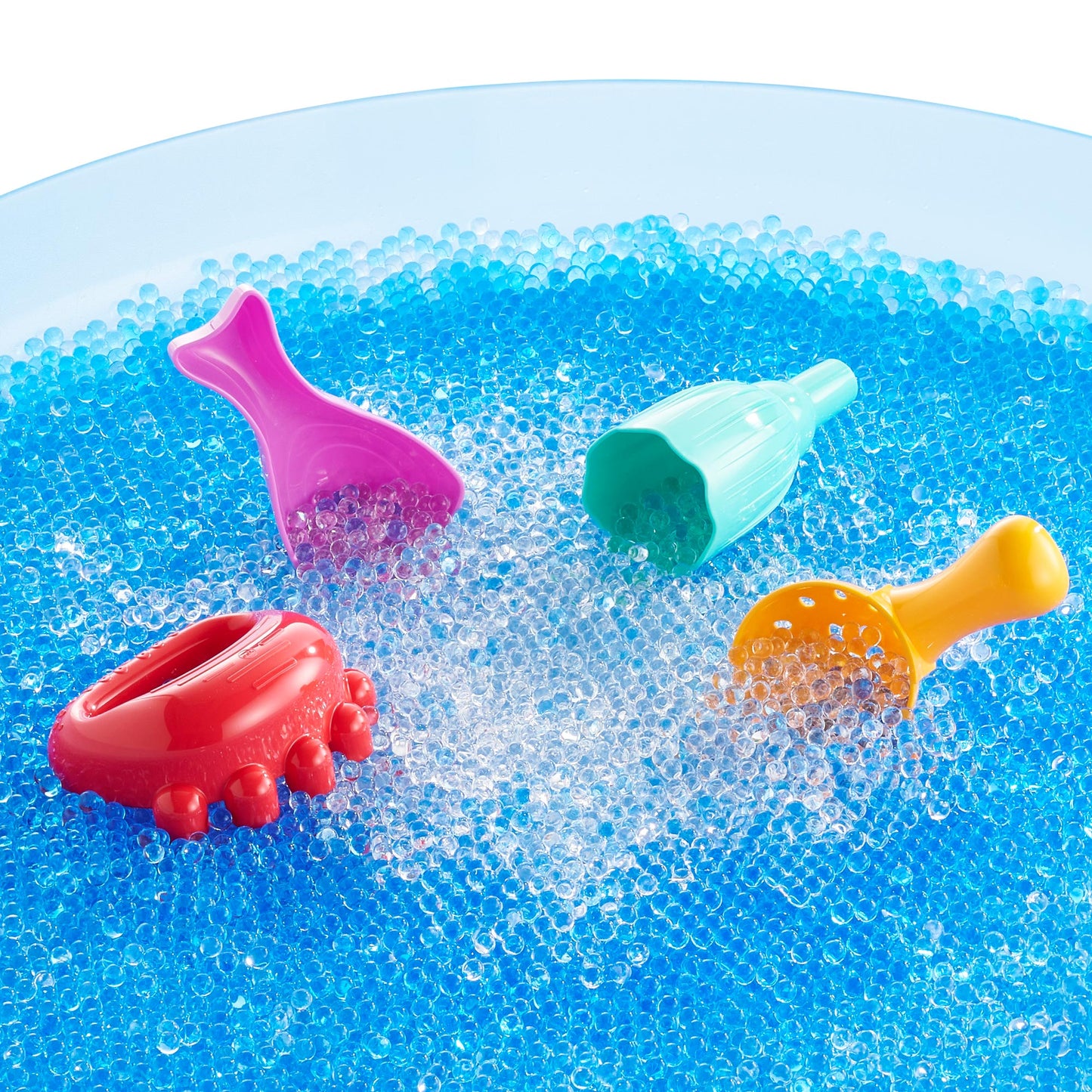 Busy_Play_iSense_Scoops-4pcs Colorful sensory play scoops for kids in water beads – red, purple, yellow, and green plastic scoops for tactile play.